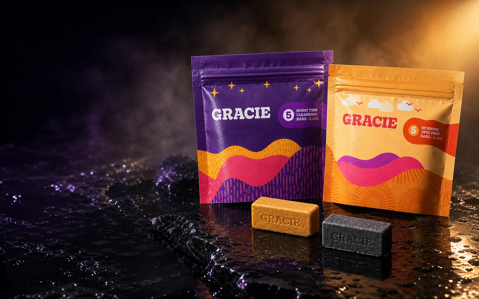 Gracie Morning and Evening pouches with gold and charcoal mini bars on a cinematic wet stone set